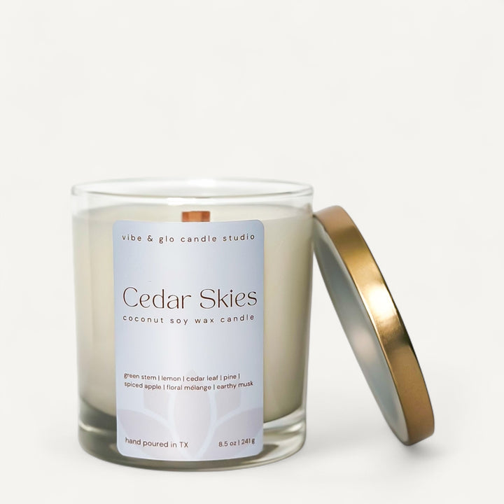 Vibe & Glo Cedar Skies candle with a blue label on a white background