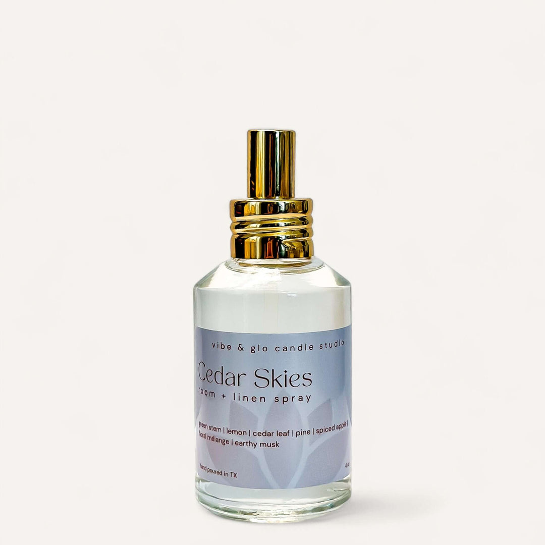 Cedar Skies Room & Linen Spray bottle featuring cedar, pine, and spiced apple fragrance for home freshness.