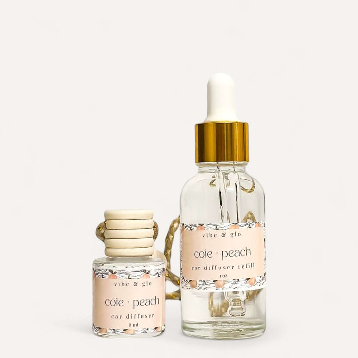 Car diffuser and refill set featuring a peach scent by Vibe & Glo, perfect for a fresh-smelling car.