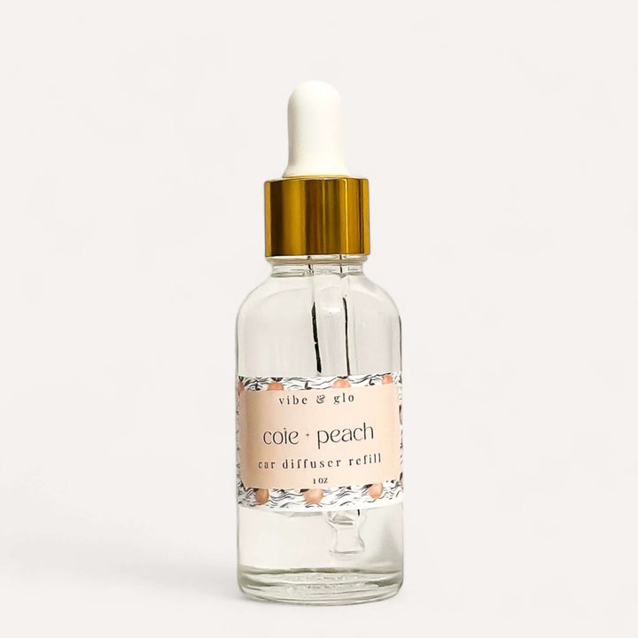 Vibe & Glo 1 oz Car Diffuser Refill in Coie Peach scent, featuring a dropper bottle for easy use.