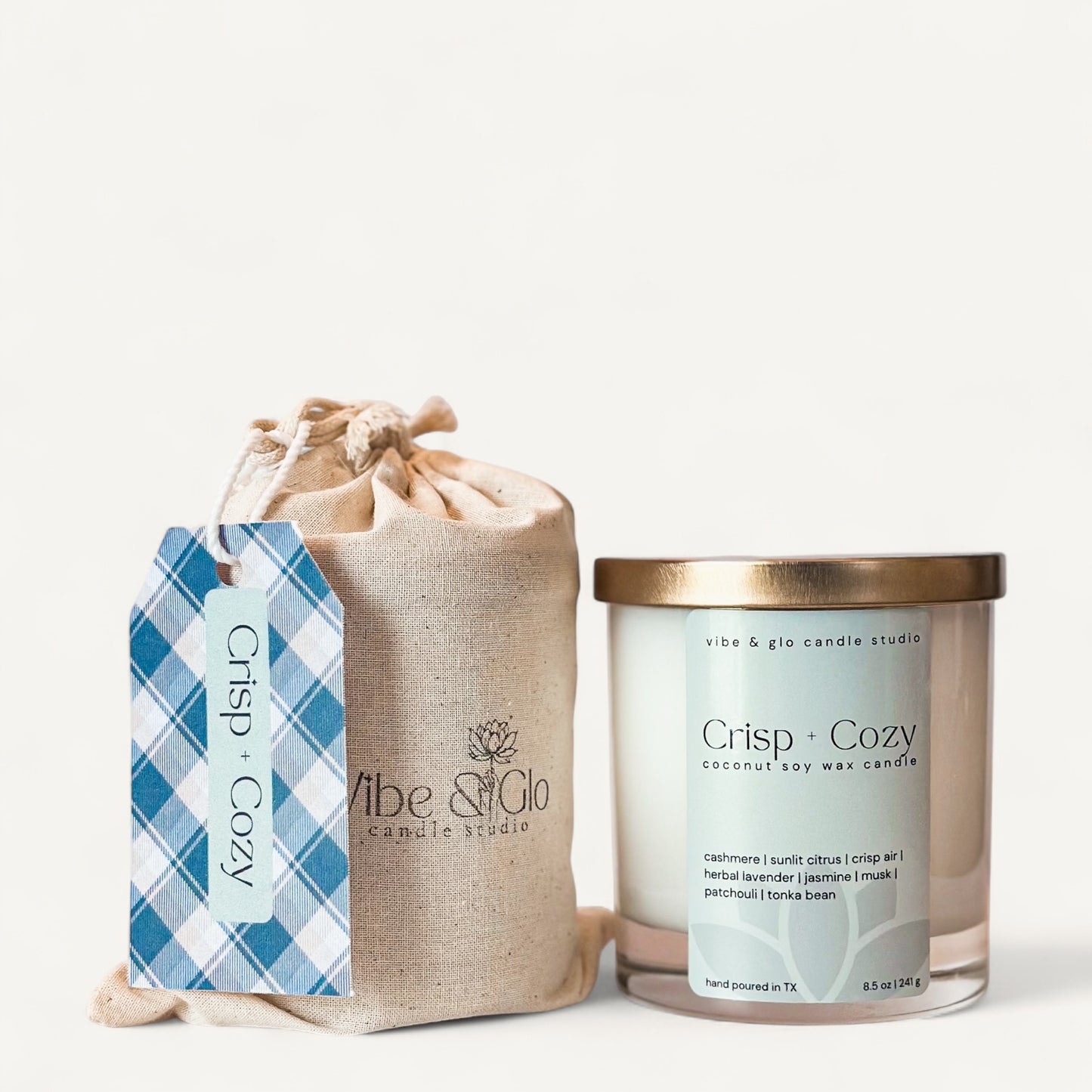 Crisp + Cozy candle in a jar with a cozy label, made from coconut soy wax, featuring citrus and lavender scents.