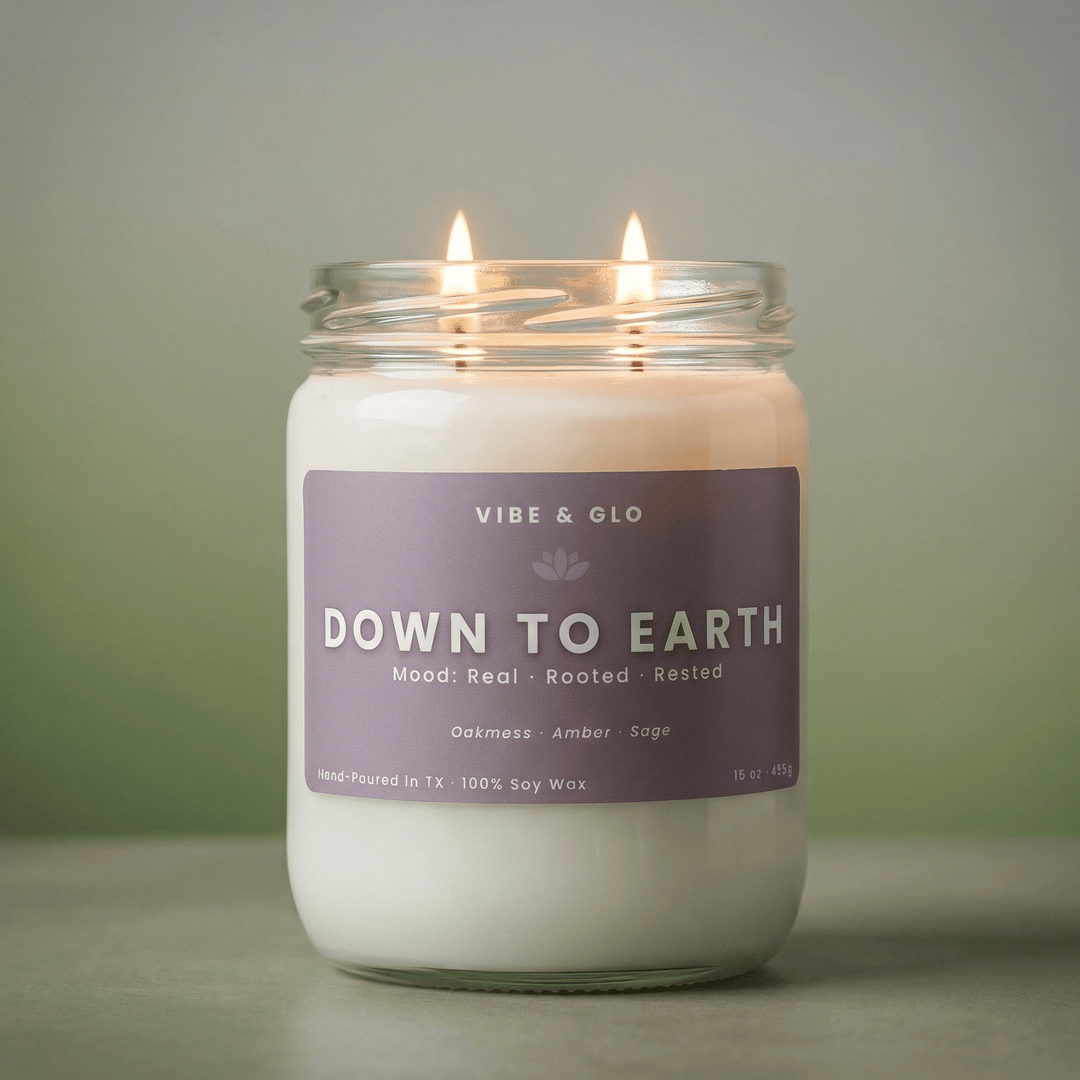 down to earth 16 oz double wick soy candle lit soft glow amber sage scent clean burning candle vibe and glo