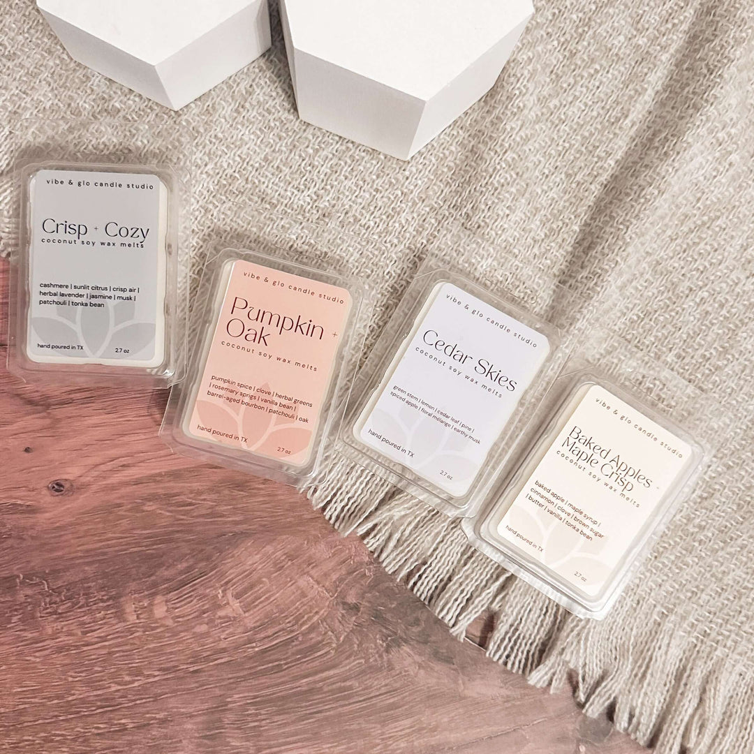 Four wax melts with labels on a textured surface