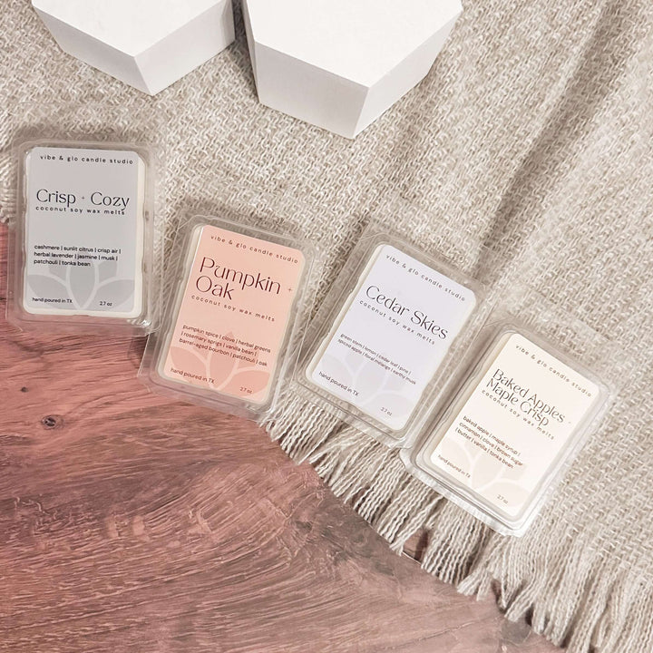 Four wax melts with labels on a textured surface