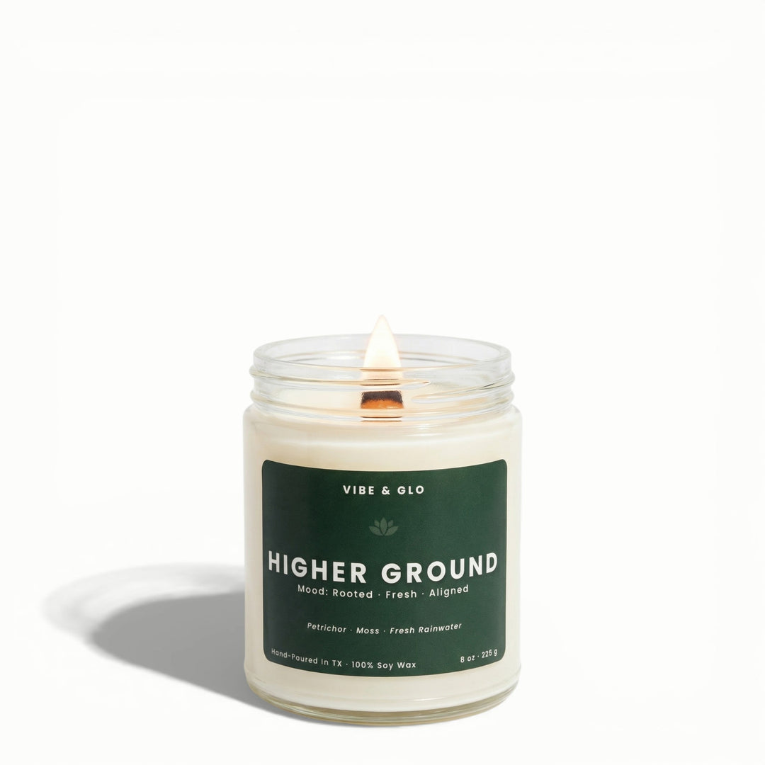Higher Ground wooden wick soy candle by Vibe & Glo with petrichor, moss, and fresh rainwater in clear 8 oz jar.