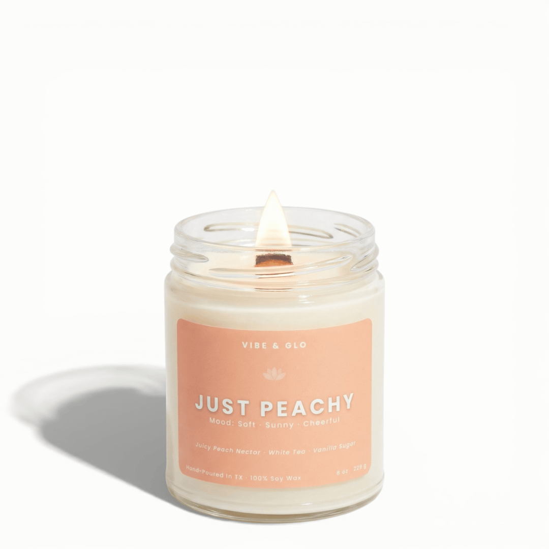 Just Peachy wooden wick soy candle by Vibe & Glo with juicy peach nectar, white tea, and vanilla sugar in 8 oz jar.
