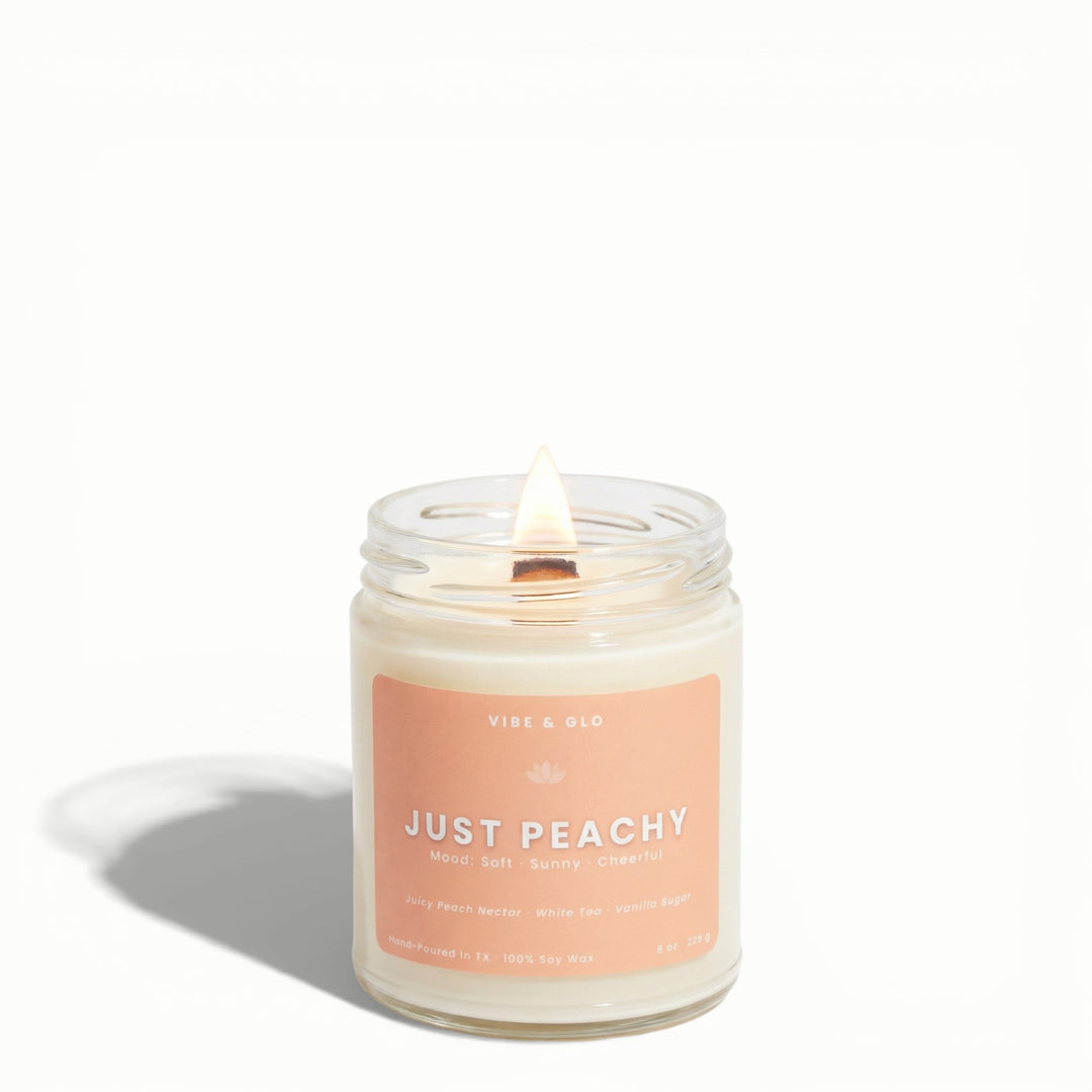 Just Peachy wooden wick soy candle by Vibe & Glo with juicy peach nectar, white tea, and vanilla sugar in 8 oz jar.