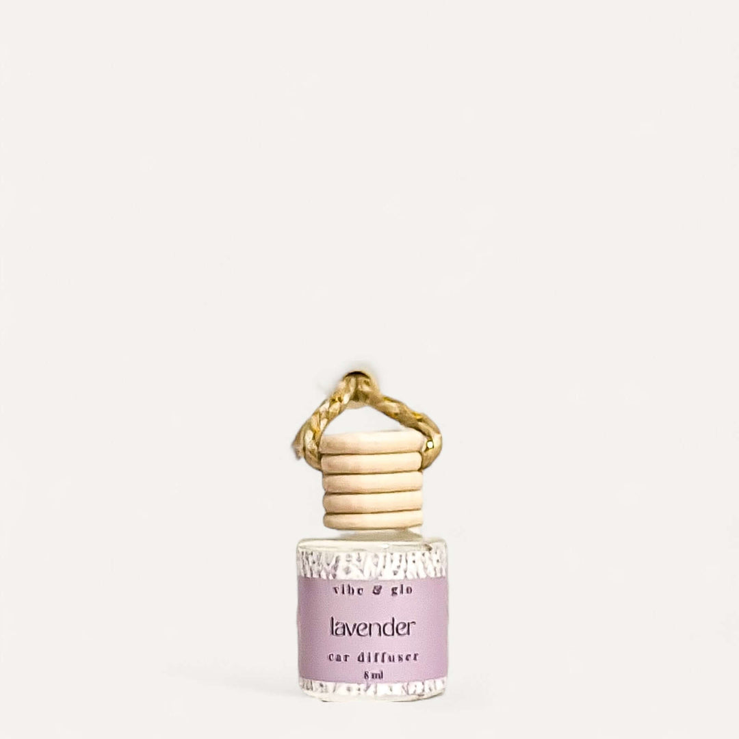 Lavender car air diffuser in elegant glass bottle with wooden cap, designed for long-lasting fragrance.