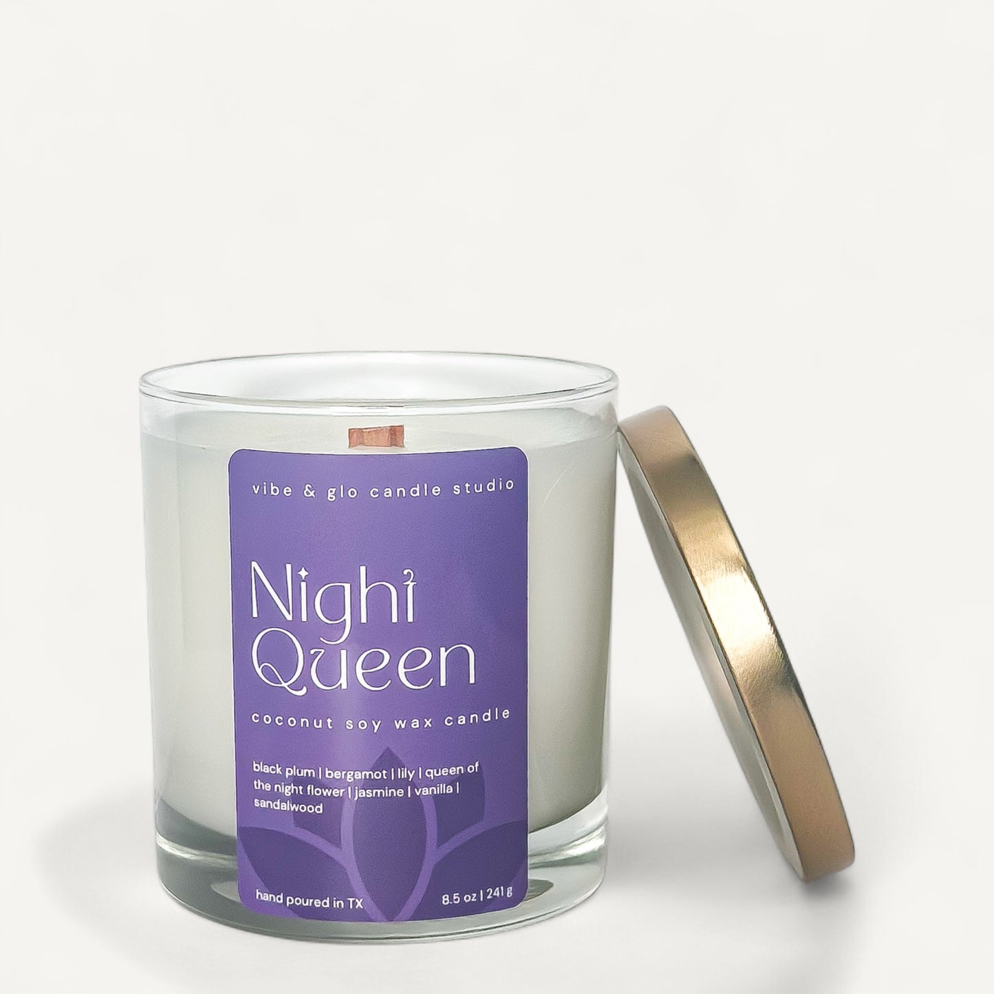 Night Queen coconut soy wax candle with a purple label and gold lid, featuring floral and fruity scents.