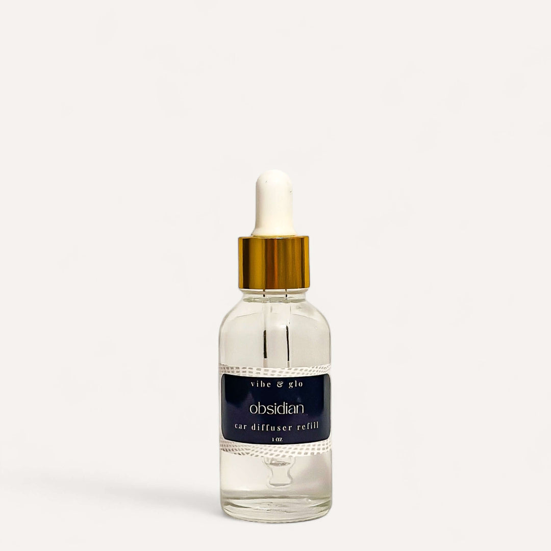 Obsidian car diffuser refill in a 1 oz dropper bottle for hanging diffusers by Vibe & Glo.