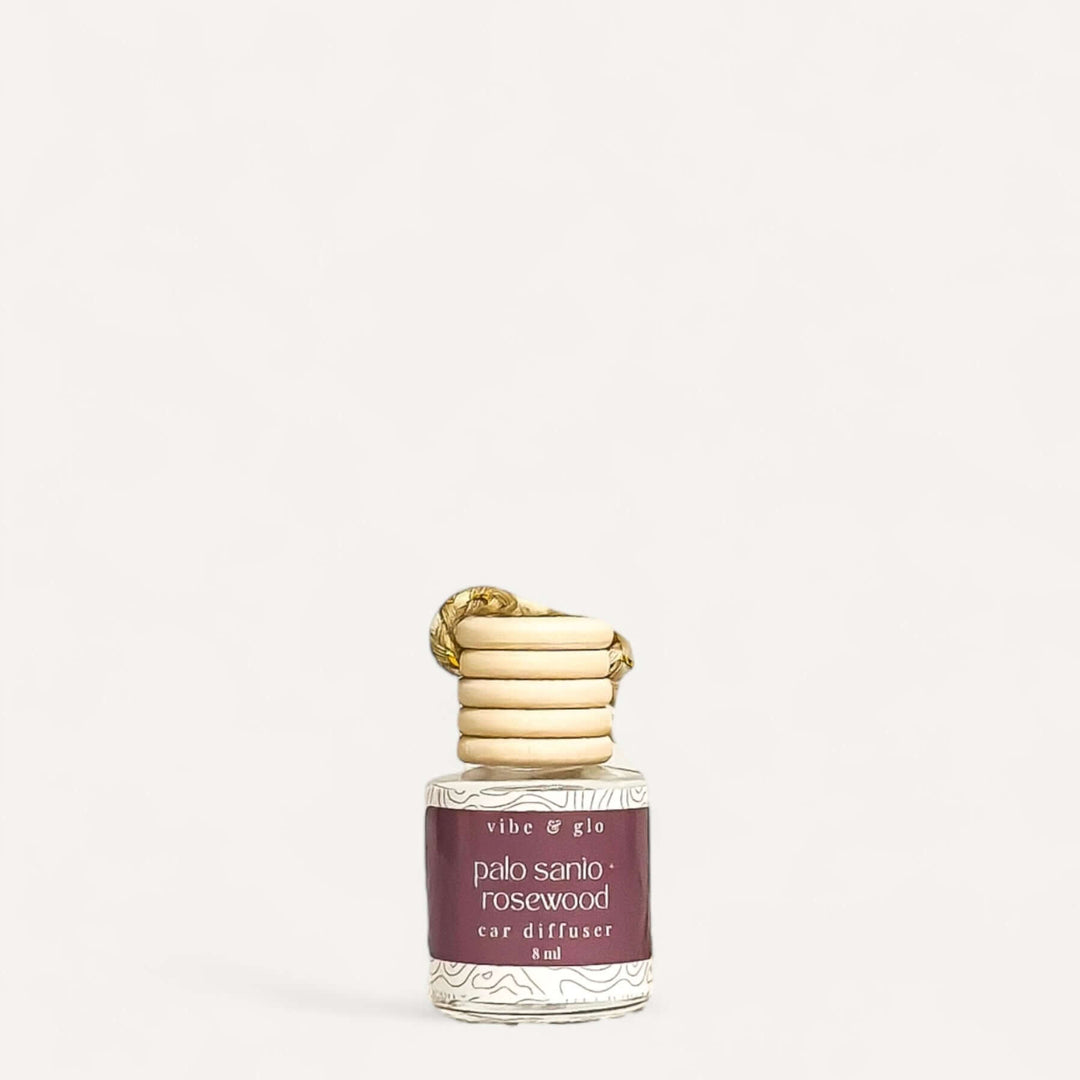 Refillable car air freshener featuring Palo Santo and Rosewood scent in elegant glass diffuser.