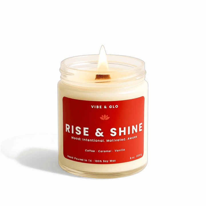 Candle in a jar with a red label reading 'Rise & Shine' on a white background