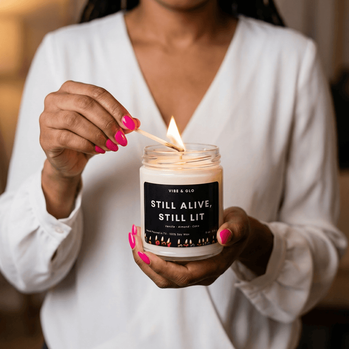 lighting a still alive still lit candle vibe and glo funny birthday candle hands lighting wick close up