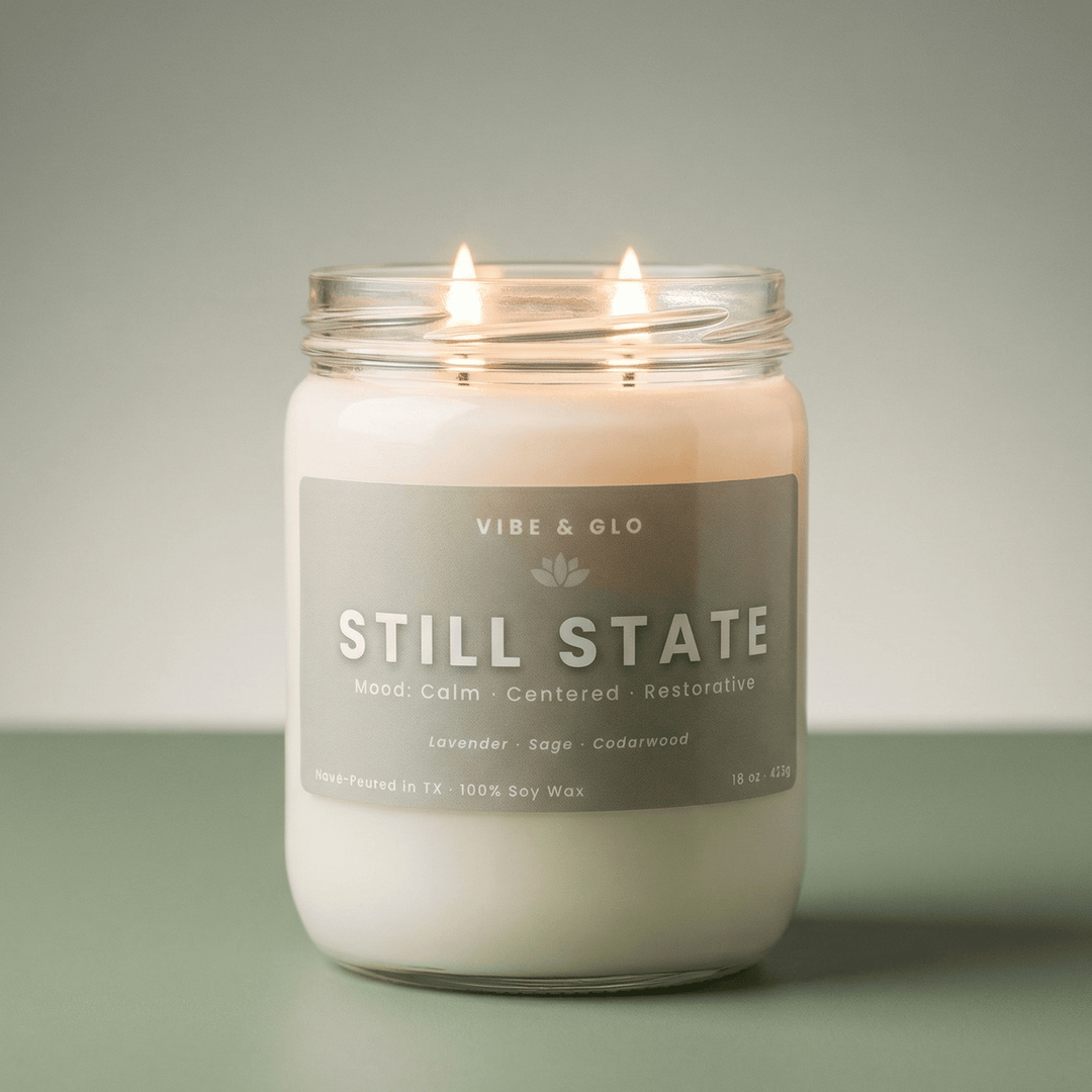 Lit Still State double wick soy candle with lavender and sage notes by Vibe & Glo, styled in a soft, calming minimalist home fragrance scene.