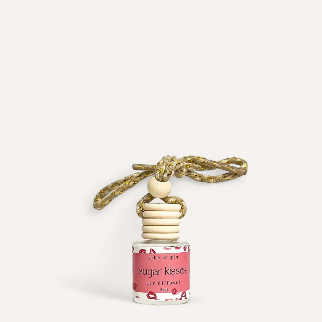 Refillable car air freshener in 'Sugar Kisses' scent, stylish glass diffuser with a decorative rope for hanging.