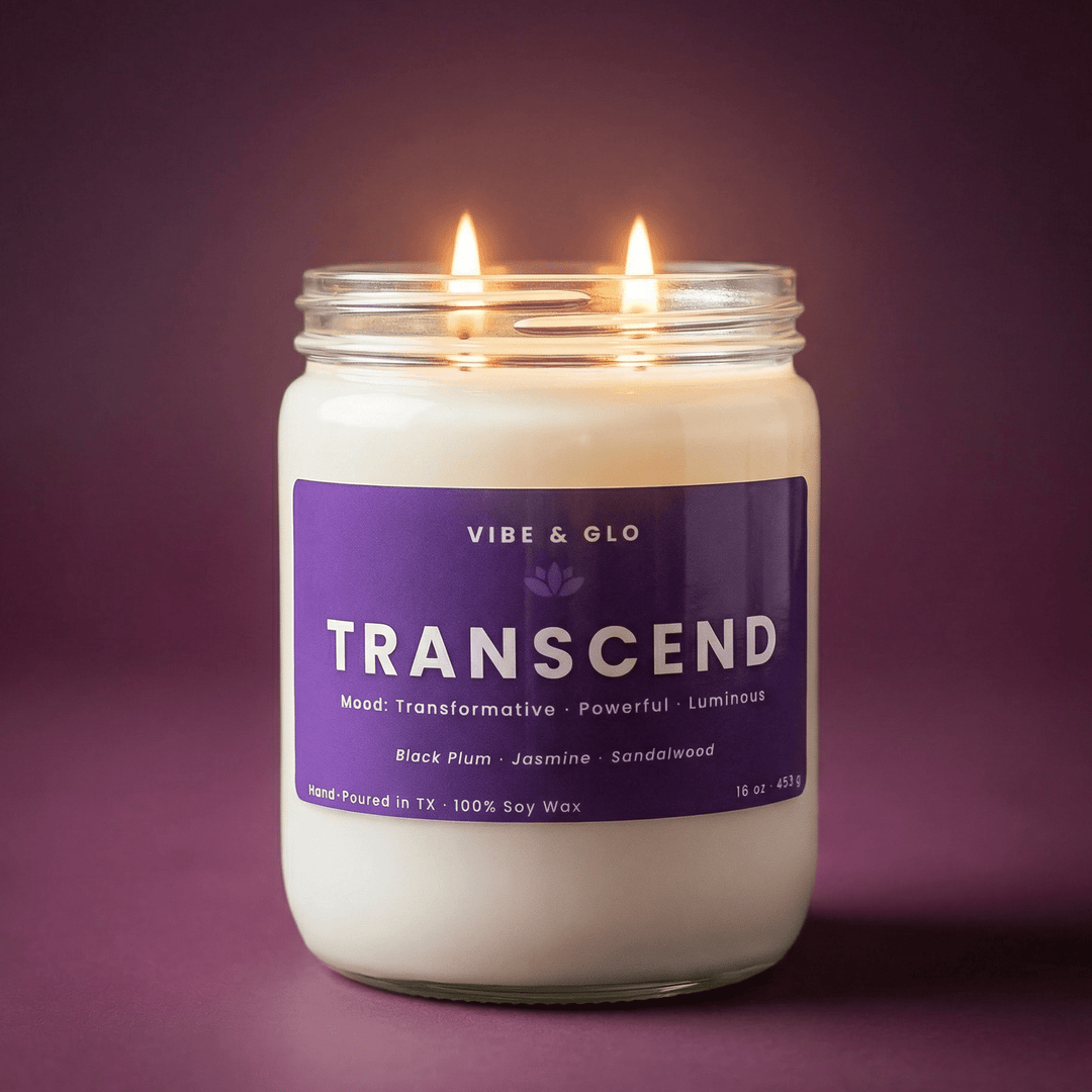 Close-up of a lit Transcend 16 oz double wick soy candle against a deep purple background, highlighting the soft glow and clean burn for a modern, elevated home fragrance look.
