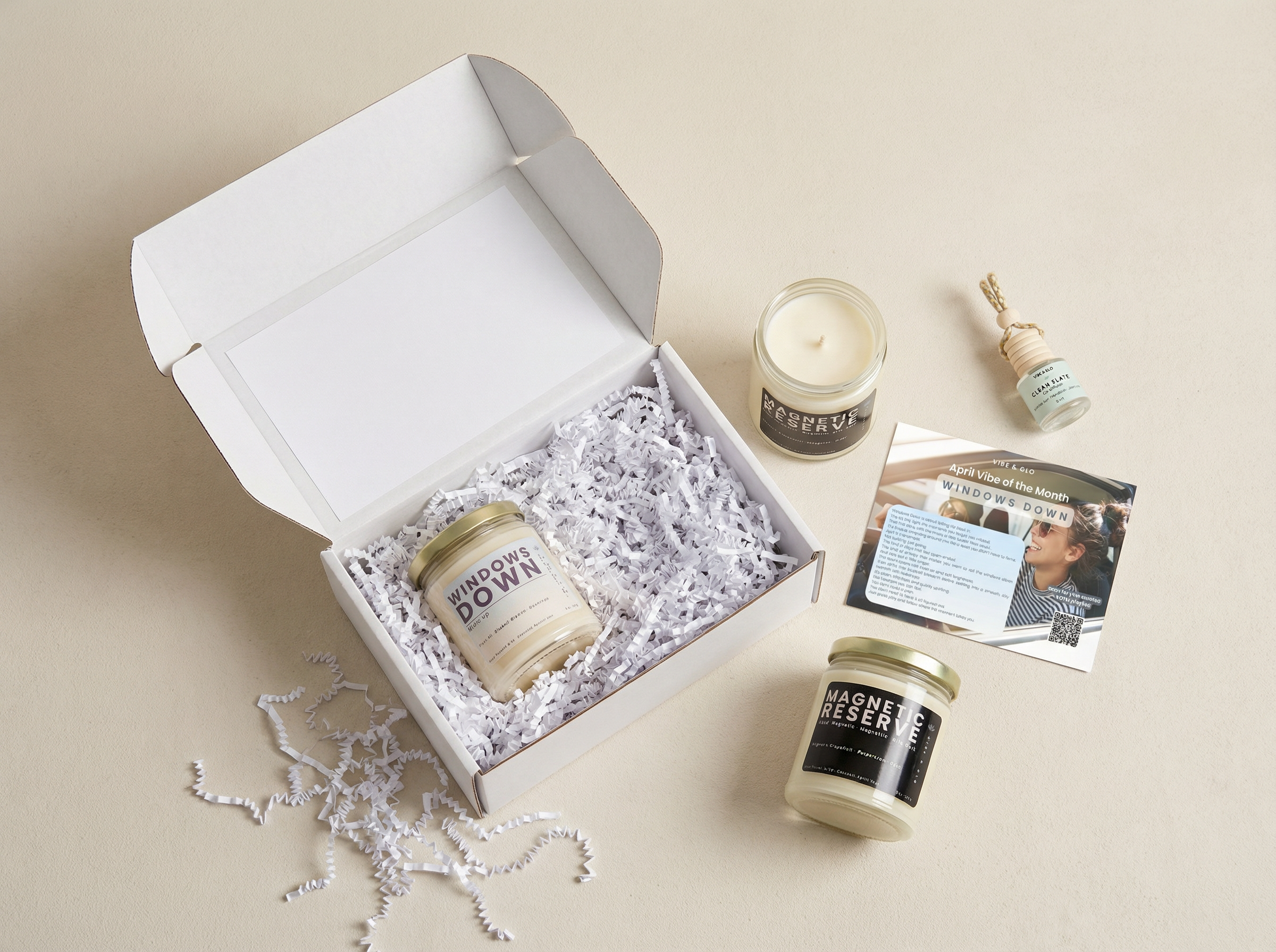 Vibe of the Month Windows Down candle subscription box by Vibe & Glo with candle, car diffuser, and inserts styled in a clean neutral flatlay