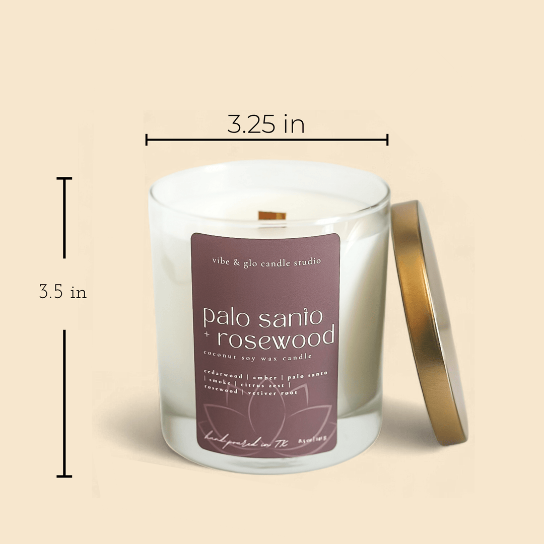 Coconut soy wax candle in clear jar labeled Palo Sanio + Rosewood with gold lid and size dimensions.