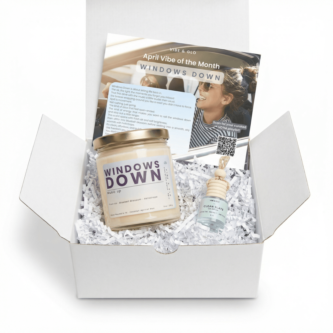Windows Down April candle subscription box by Vibe & Glo featuring single candle, hanging car diffuser, and monthly insert card in white gift box
