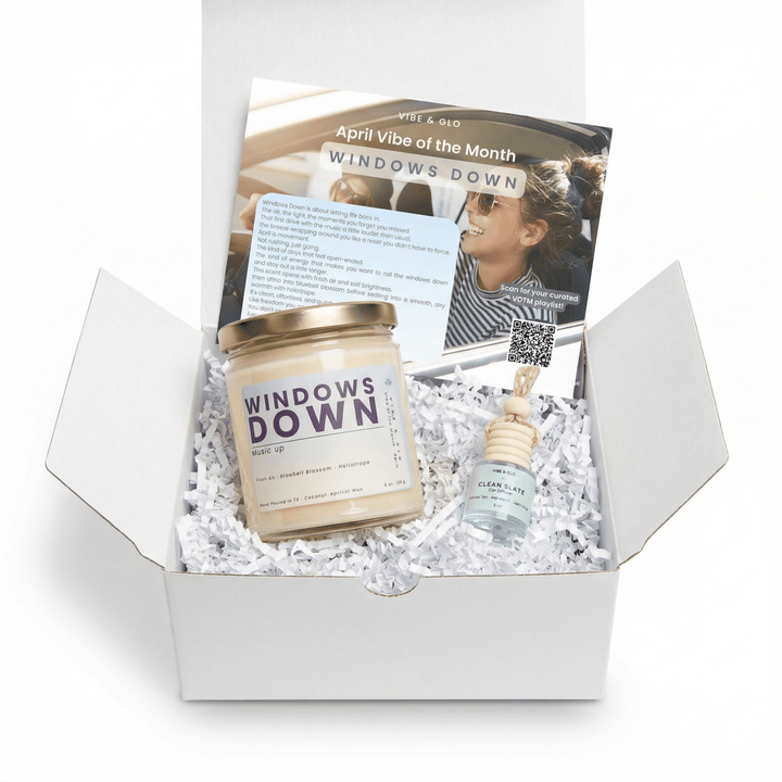 Windows Down April candle subscription box by Vibe & Glo featuring single candle, hanging car diffuser, and monthly insert card in white gift box